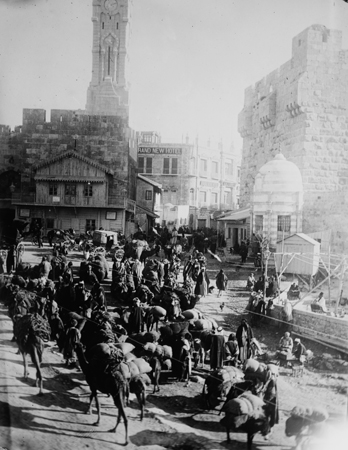 A camel train passing through the Jaffa Gate in Jerusalem. Palestine, c. 1914, <em>Library of Congress, LC-DIG-ggbain-11825</em>.
