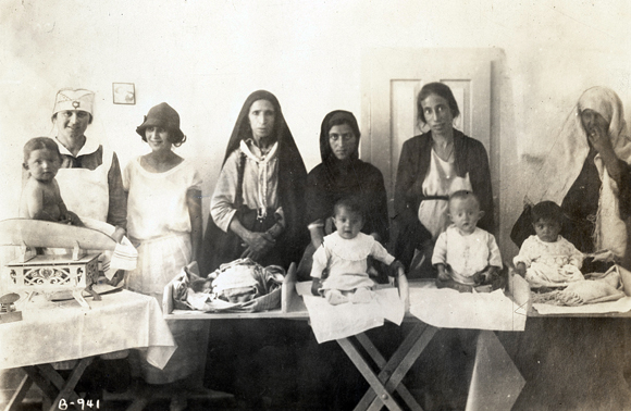 Child care assistance expanded to instruct new mothers in infant care at Hadassah child welfare centers. Palestine, c. 1920, <em>NY_00011</em>.

