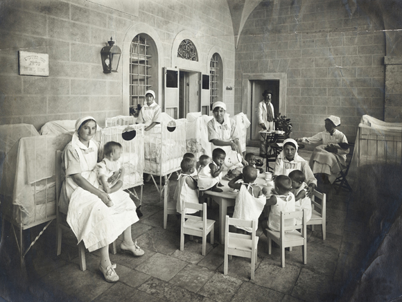 The Palestine Orphan Committee sent out a network of social workers to visit more than 4,000 orphans supported in institutions and in private homes in Jerusalem, Jaffa, Haifa, Tiberias, Safed, Hebron, and elsewhere in Palestine. Unified record-keeping made it possible to keep track of each child. Infants slept peacefully at the Aliza Maon Infants Orphanage. Palestine, c. 1920, <em>NY_00017</em>. 
