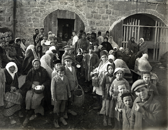 Through the entire war, JDC fed Jerusalems hungry through existing facilities, such as the Teresa Dreyfus and Nathan Straus Soup Kitchens, and through newly created kitchens and distribution centers. In 1921, 1,800 poor from all backgrounds were still receiving at least one meal a day at the Dreyfus Soup Kitchen. Palestine, c. 1921, <em>NY_00047</em>.
