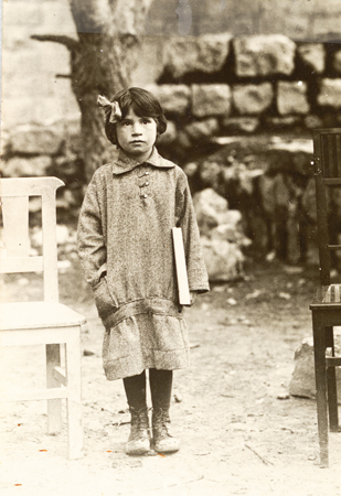By March 1915, some 12,000 refugees from Palestine had been expelled by the Turkish government to Alexandria, Egypt. They lived there mostly in camps, with emergency relief provided by JDC. This little girl, born in one of the camps, lost her father there to typhus. Once back in Jerusalem, she received aid from JDC's newly created Palestine Orphan Committee. The amount allotted for each child was generally based on whether one parent or none remained. Palestine, c. 1924, <em>NY_00213</em>.
