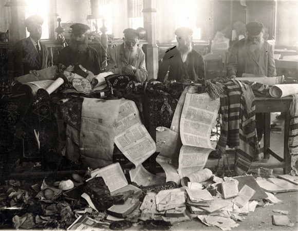 After the Kiev pogrom in May 1920, members of the Demiev Synagogue salvaged what they could of their congregation's torn Torah scrolls. Ukraine, c. 1920, <em>NY_00438</em>.
