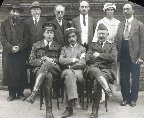 In the aftermath of the May 1920 pogrom, JDC sent Overseas Unit 1 representatives to Polish-controlled Kiev. Captain Elkan Voorsanger and Dr. Charles Spivak (respectively seated in uniform) helped community leaders establish a local relief committee, providing them with money, food, and emergency supplies. Ukraine, c. 1920, <em>NY_00440</em>.
