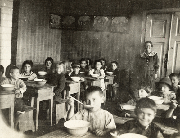 Throughout the war, JDC provided meals for children at schools and nurseries. At Mendele's Kindergarten and Community School in Bialystok, a hot lunch was much appreciated. Poland, 1918, <em>NY_01435</em>. 

