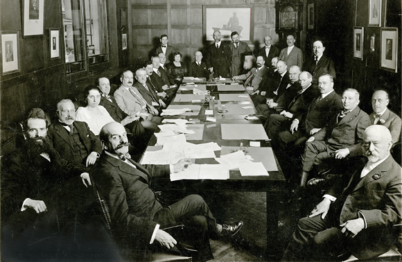 The Joint Distribution Committee met regularly to resolve a shifting array of challenges. This meeting took place in the office of JDCs Chairman Felix Warburg (front center). One of its major supporters, Jacob Schiff, was seated to his right. U.S., 1918, Underwood and Underwood, <em>NY_03405</em>.

