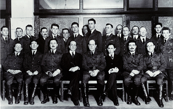 Overseas Unit No. 1 arrived in Paris en route to Poland in February 1920. Their official dress was a modified version of the U.S. Army uniform. JDC's Director for Poland, Boris Bogen (seated, fourth from left), led the team. The Jewish Welfare Board's Overseas Director, Elkan Voorsanger (seated, fifth from left), was Unit Manager. A second unit followed later that year. France, c. 1920, <em>NY_03406</em>.
