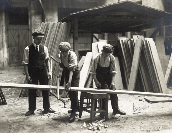 Education opportunities were developed for the more employable trades. In this carpentry workshop in Kracow, boys were taught building skills. Poland, c. 1920, <em>NY_03917</em>.
