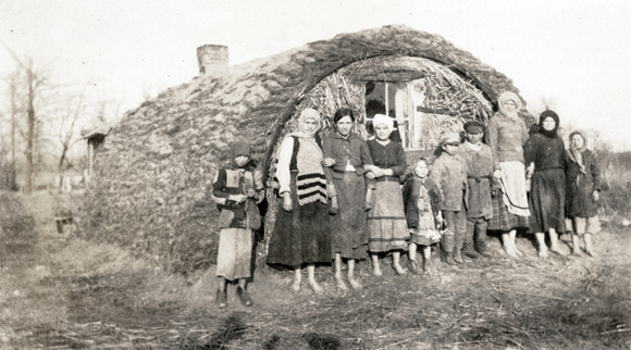 Bringing what meager household goods could be rescued amid the terror of war and political upheavals, caravans of homeless, starving, and sometimes ill Jews arrived without money or a place to sleep in the towns along the Polish border. Refugees shared a makeshift house on the road between Kovel and Rovno. Poland (now Ukraine), c. 1920, <em>NY_05059</em>.
