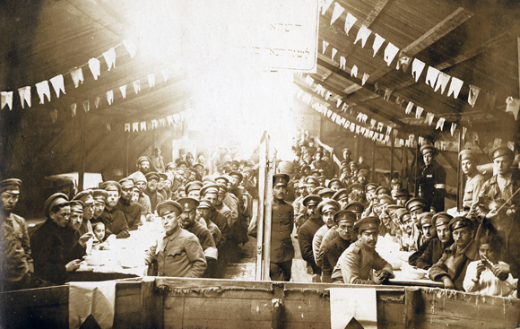 Jewish prisoners of war received JDC food packages through Holland and the Red Shield of David Society in Switzerland. For Passover 1917 and 1918, JDC obtained special War Trade Board licenses to send matzoh to POW's, chiefly from Russia and Romania, in German camps. A Passover meal at Skalmiershutz, five miles from the Polish frontier. Germany, 1917, <em>NY_36363</em>.
