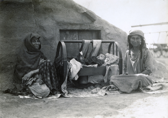 Most colonies included settlers from diverse parts of the former Russian Empire. A few, though,  were comprised of distinct groups, such as the Caucasian Mountain Jews. These women from the Caucasus settled in Jankoy. Like many new settlers, they started out living in an earthen hut. Crimea, 1929, <em> NY_42869 (from YIVO)</em>.