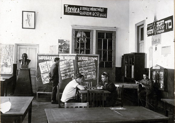 Living accommodations were difficult to come by in big cities, so Agro-Joint provided free dormitories to students attending the factory schools. Having grown up in a time of painful disorder, the relative normalcy of communal dormitory life may have been as valuable for students as the professional training they received. At the Ratmansky School Factory in Kiev, where 98% of the students were “out-of-towners,” the dormitory housed around 350. Ukraine, early 1930’s, <em>NY_43278 (from YIVO)</em>.