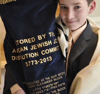 A White Plains bar mitzvah boy reads from a 200-year-old Belgrade Torah
