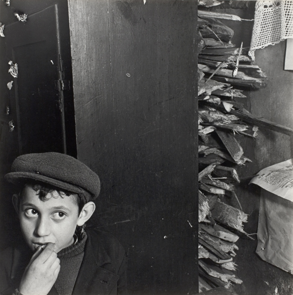 Roman Vishniac [Boy with kindling in a basement dwelling, Krochmalna Street, Warsaw], ca. 1935-38 Mara Vishniac Kohn, courtesy International Center of Photography